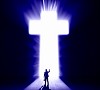 Silhouette of businessman against cross in light