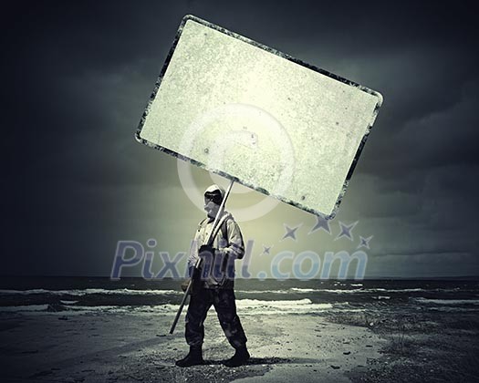 Stalker in gas mask with blank banner. Disaster concept Stalker in gas mask with blank banner. Disaster concept