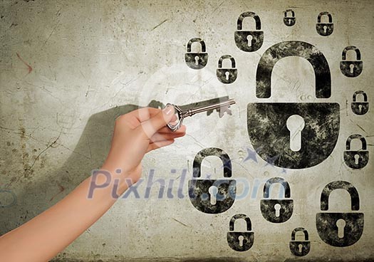 Close up image of human hand holding key Close up image of human hand holding key
