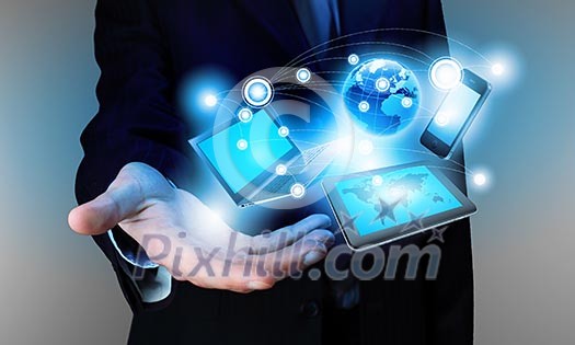 Image of business person holding devices in hands