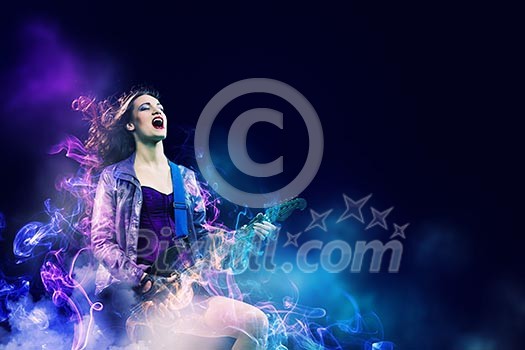 Young attractive rock girl playing the electric guitar Young attractive rock girl playing the electric guitar