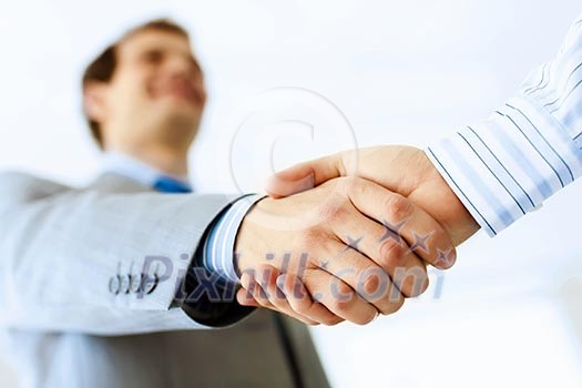 Close up image of business handshake at meeting. Partnership concept Close up image of business handshake at meeting. Partnership concept