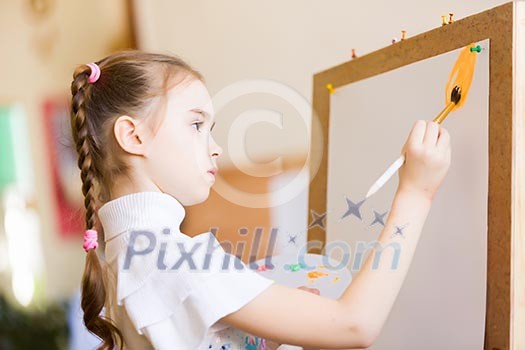 Little cute girl with paint brush and easel Little cute girl with paint brush and easel