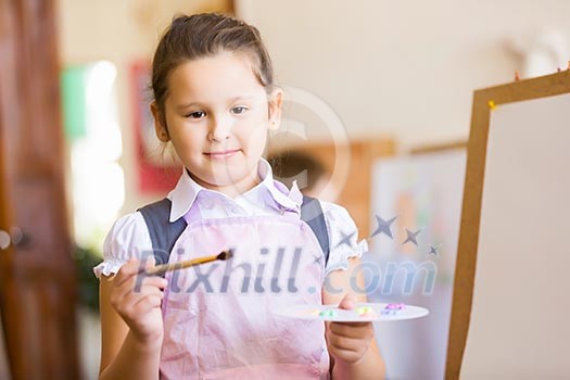 Little cute girl with paint brush and easel Little cute girl with paint brush and easel