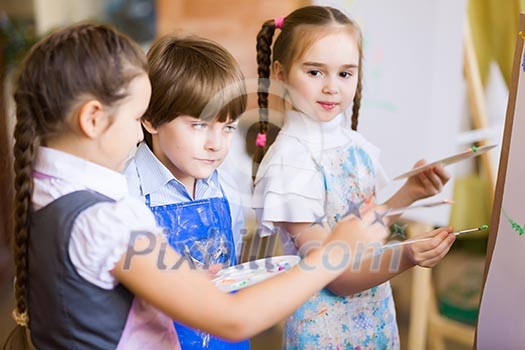 Little children painting and playing at kindergarten Little children painting and playing at kindergarten