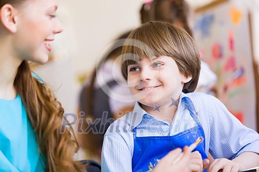 Young teacher and children painting and playing Young teacher and children painting and playing
