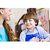 Young teacher and children painting and playing