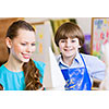 Young teacher and children painting and playing