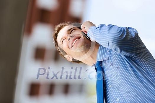 Image of handsome businessman speaking on mobile phone Image of handsome businessman speaking on mobile phone