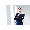 Image of young attractive businesswoman in business suit smiling