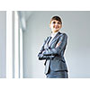 Image of young attractive businesswoman in business suit smiling