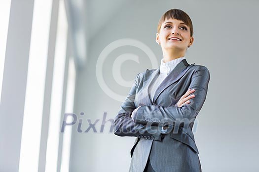 Image of young attractive businesswoman in business suit smiling Image of young attractive businesswoman in business suit smiling