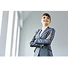 Image of young attractive businesswoman in business suit smiling
