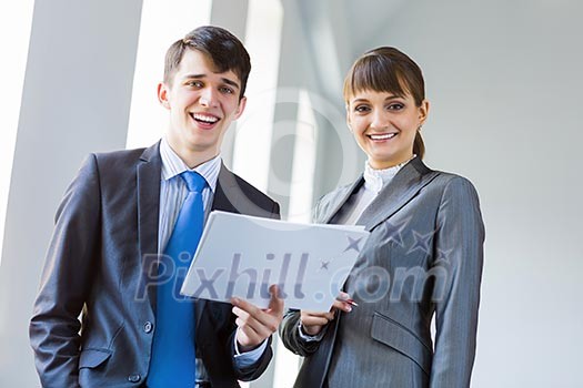 Young happy businessman and businesswoman people discussing project Young happy businessman and businesswoman people discussing project