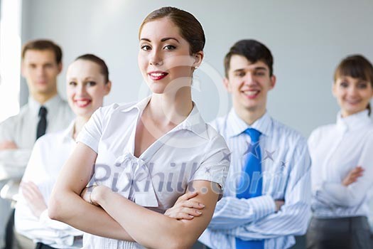 Young smiling businesswoman with colleagues. Leadership concept Young smiling businesswoman with colleagues. Leadership concept