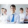 Young smiling businessman with colleagues. Leadership concept