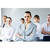 Young business people standing with arms crossed on chest