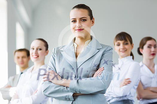 Young smiling businesswoman with colleagues. Leadership concept Young smiling businesswoman with colleagues. Leadership concept