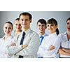 Young business people standing with arms crossed on chest