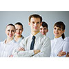 Young business people standing with arms crossed on chest