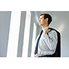 Handsome smiling businessman holding jacket on his shoulder