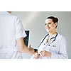 Attractive young female doctor examining x-ray results