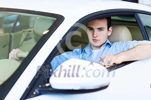 Image of young handsome guy sitting in car Image of young handsome guy sitting in car