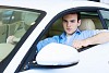 Image of young handsome guy sitting in car