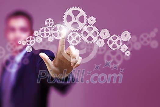 Image of businessman touching gear elements. Mechanism concept Image of businessman touching gear elements. Mechanism concept