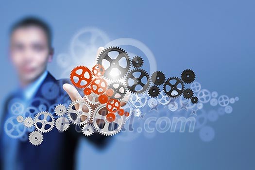 Image of businessman touching gear elements. Mechanism concept Image of businessman touching gear elements. Mechanism concept