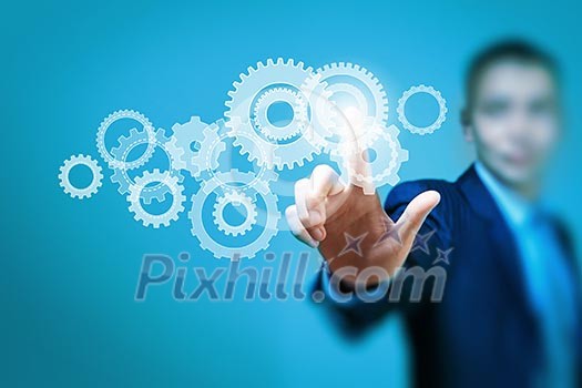 Image of businessman touching gear elements. Mechanism concept Image of businessman touching gear elements. Mechanism concept