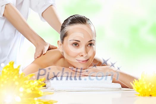 Young pretty woman with clear skin at spa salon getting massage Young pretty woman with clear skin at spa salon getting massage