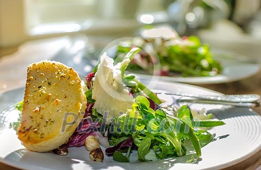 A plate of salad and garlic bread A plate of salad and garlic bread