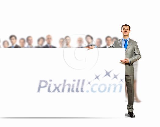 Image of young man holding blank banner with crowd of business people at background Image of young man holding blank banner with crowd of business people at background