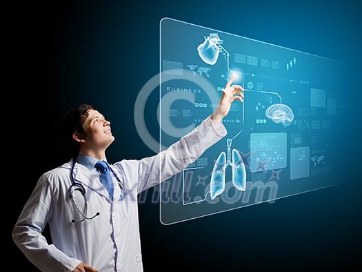 Young male doctor touching icon on media screen Young male doctor touching icon on media screen