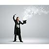Image of magician holding hat with lights and fumes going out