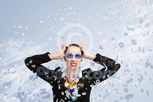 Image of irritated businesswoman in goggles with business collage at background Image of irritated businesswoman in goggles with business collage at background
