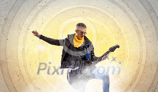 Young man, rock musician in jacket with guitar Young man, rock musician in jacket with guitar