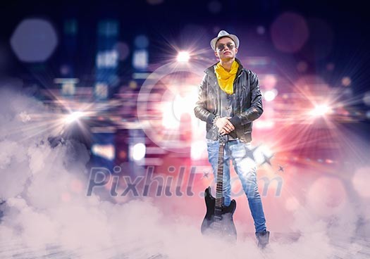 Young man, rock musician in jacket with guitar Young man, rock musician in jacket with guitar