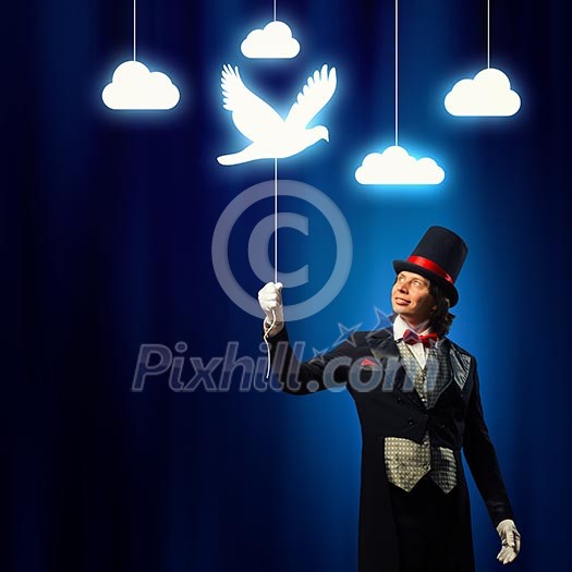 Image of man magician showing trick against color background Image of man magician showing trick against color background