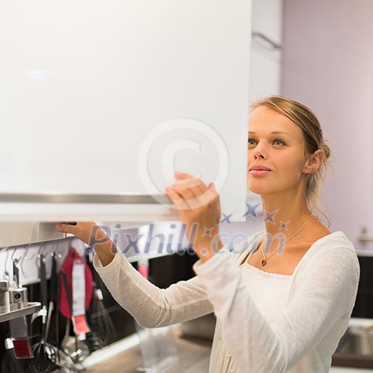 Pretty, young woman choosing the right furniture for her apartment in a modern home furnishings store (color toned image; shallow DOF) Pretty, young woman choosing the right furniture for her apartment in a modern home furnishings store (color toned image; shallow DOF)