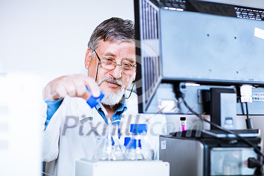 Senior male researcher carrying out scientific research in a lab (shallow DOF; color toned image) Senior male researcher carrying out scientific research in a lab (shallow DOF; color toned image)
