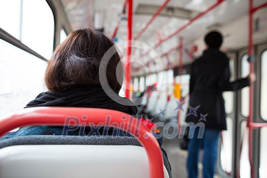 Public transport series - taking a tram commute to work/school (color toned image; shallow DOF) Public transport series - taking a tram commute to work/school (color toned image; shallow DOF)