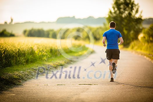 Male athlete/runner running on road - jog workout well-being concept Male athlete/runner running on road - jog workout well-being concept