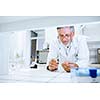 Senior male researcher carrying out scientific research in a lab (shallow DOF; color toned image)