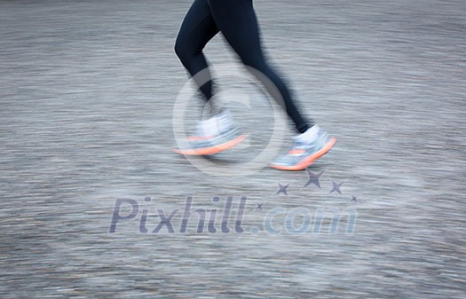 Motion blurred runner's feet in a city environment (panning technique used -> motion blurred image; color toned image) Motion blurred runner's feet in a city environment (panning technique used -> motion blurred image; color toned image)