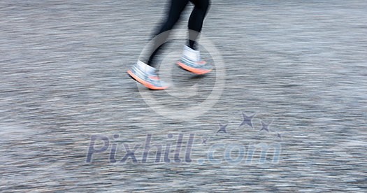 Motion blurred runner's feet in a city environment (panning technique used -> motion blurred image; color toned image) Motion blurred runner's feet in a city environment (panning technique used -> motion blurred image; color toned image)