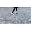Motion blurred runner's feet in a city environment (panning technique used -> motion blurred image; color toned image)