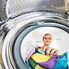 Housework: young woman doing laundry (shallow DOF; color toned image)