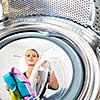 Housework: young woman doing laundry (shallow DOF; color toned image)